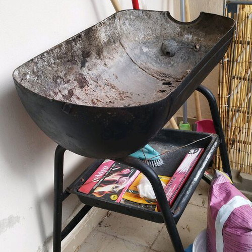 Charcoal grill used without grates with storage tray