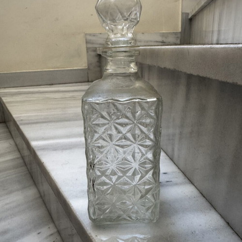 Glass liquor bottle used with embossed design