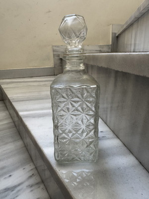 Glass liquor bottle used with embossed design