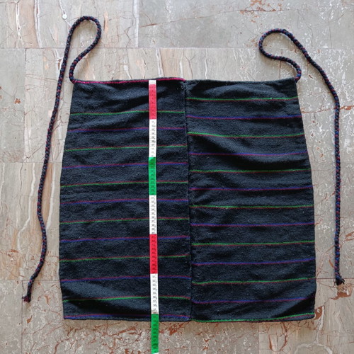 Traditional black apron with horizontal stripes used