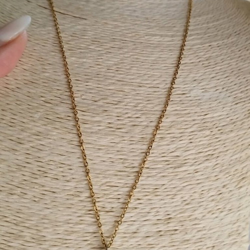 Steel necklace like new with blue mataki stone gold color