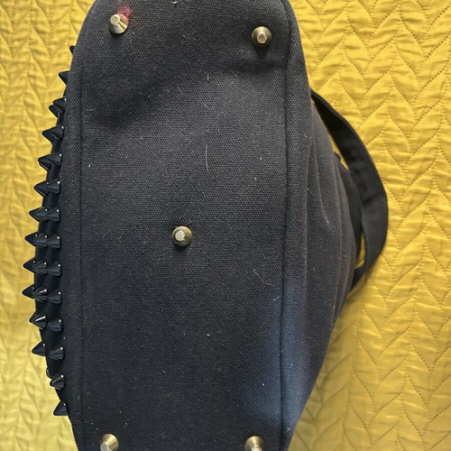 Black shoulder bag with studs used, spacious red lining