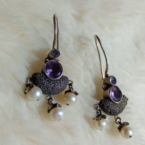 Silver earrings used with purple stones and pearls