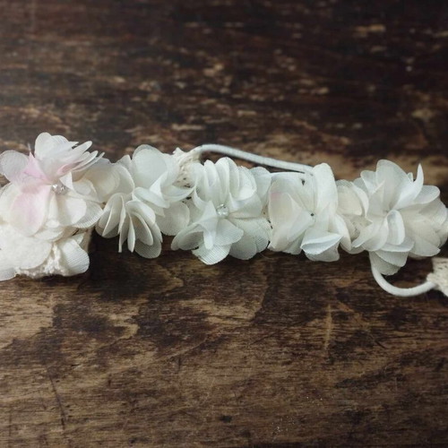 White hair ribbon wreath used for flower girl with flowers