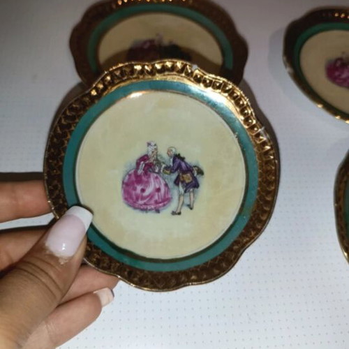 Vintage porcelain plates set of 4 with romantic design and gold trim used