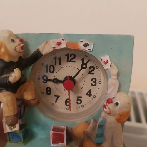 Vintage miniature table clock with clown and circus theme, used