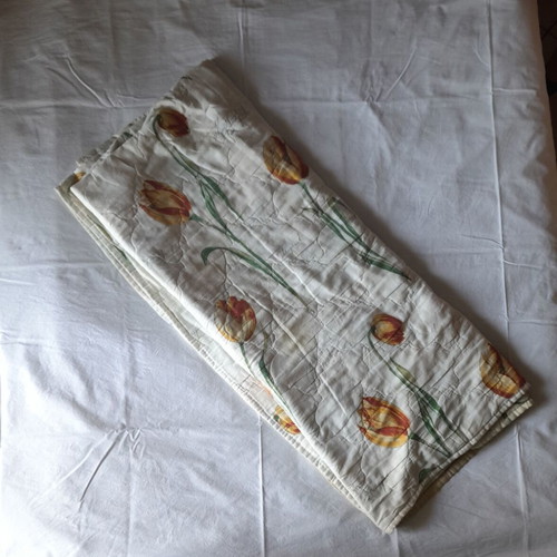 Single quilt used, white with floral patterns