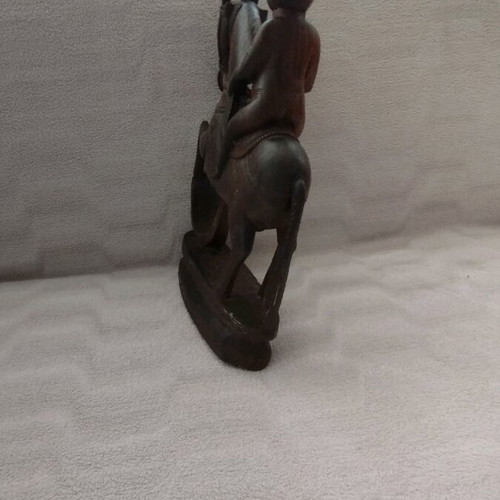 Wooden carving of South Indian man riding horse used