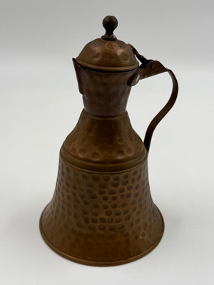 Vintage hammered copper canteen with lid used, traditional decorative vessel
