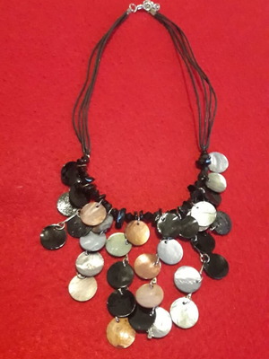 Necklace like new with cords and large discs in black, silver and gold