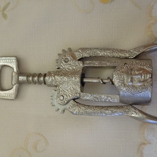 Vintage Italian metal corkscrew with embossed Bacchus design, like new