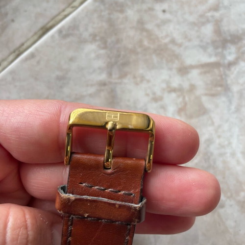 Tommy Hilfiger watch used with brown leather strap and gold dial