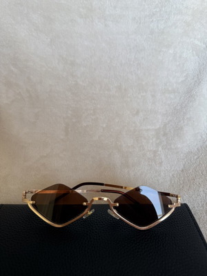 Modern geometric sunglasses with gold frame and brown lenses