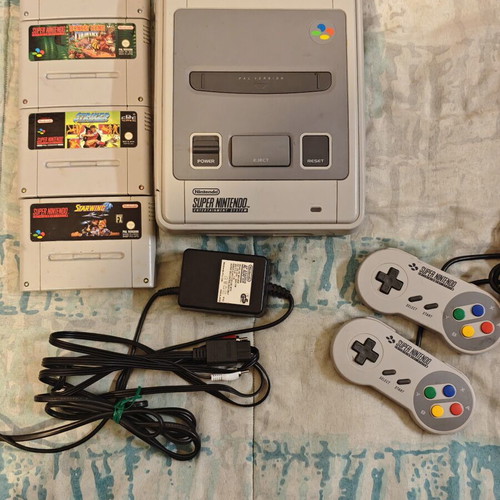 Super Nintendo Entertainment System (SNES) console with 4 games