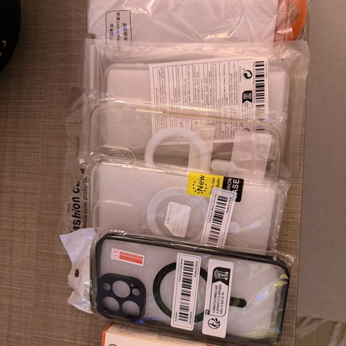 I Phone 14 Pro Max accessories with four cases, two screen protectors, and charging cable