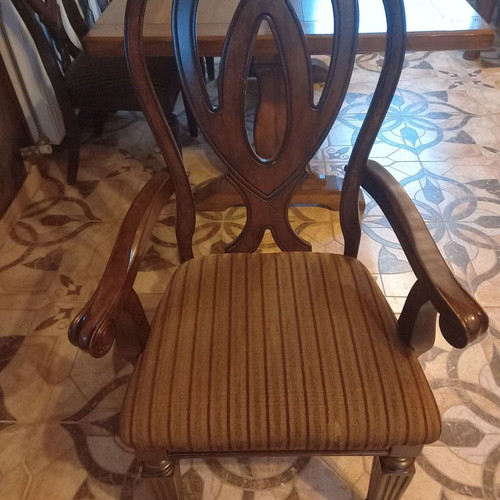 Carved Italian chairs used with mahogany fabric upholstery