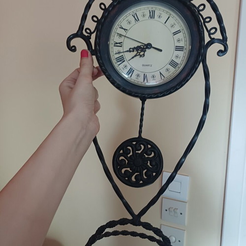 Vintage table clock with pendulum from wrought iron decorative