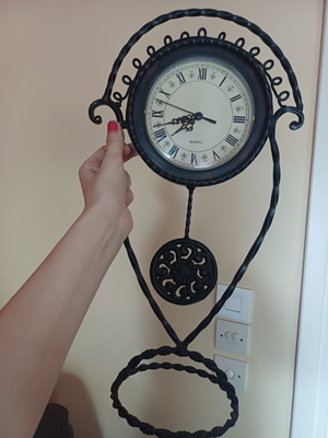 Vintage table clock with pendulum from wrought iron decorative