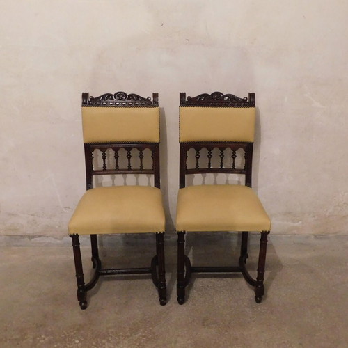 Pair of carved wooden chairs with leather seat like new, about 100 years old