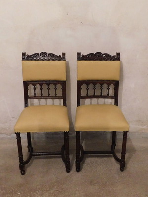 Pair of carved wooden chairs with leather seat like new, about 100 years old