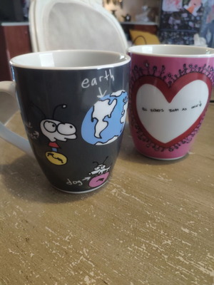 Two collectible mugs like new, featuring Moby and Charlize Theron design