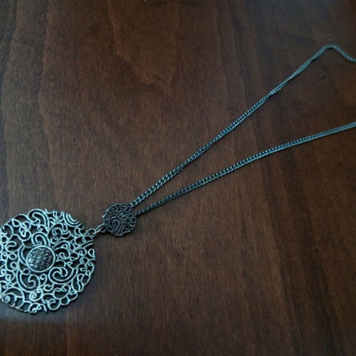 Metal pendant with pierced design used, silver color