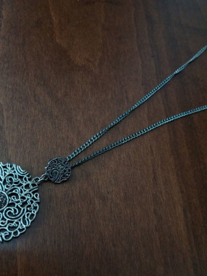 Metal pendant with pierced design used, silver color