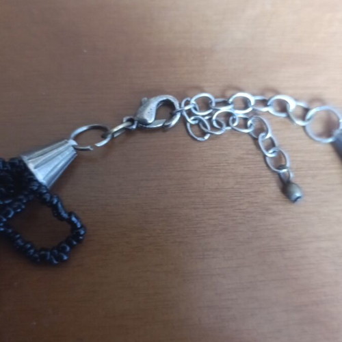 Black necklace with beads and plastic spade-shaped elements like new