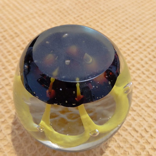 Vintage glass paperweight with yellow dome design