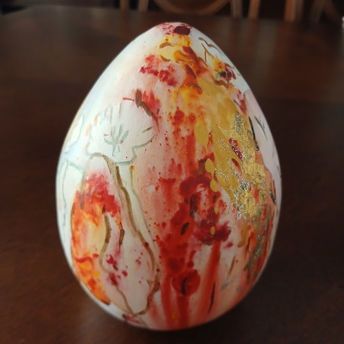 Hand-painted ceramic egg with floral and female figure design