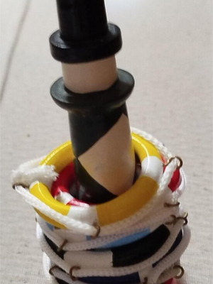 Wooden decorative lighthouse with colorful lifebuoys used