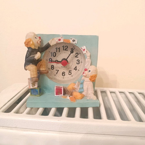 Vintage miniature table clock with clown and circus theme, used