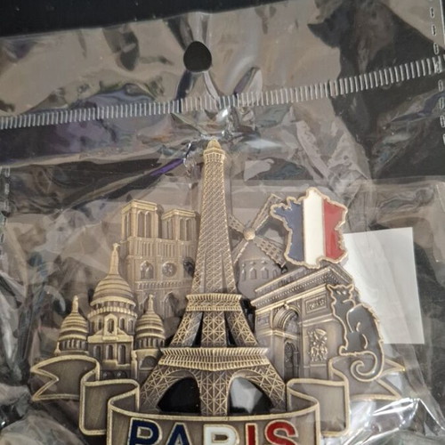 Metal souvenir magnet with Paris theme, gold color