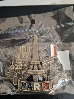 Metal souvenir magnet with Paris theme, gold color