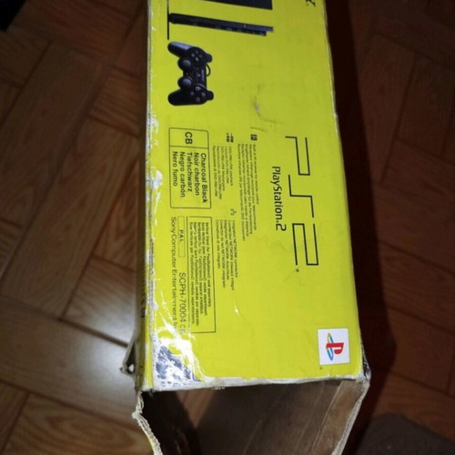 PlayStation 2 console with original controller, memory card and 2 games