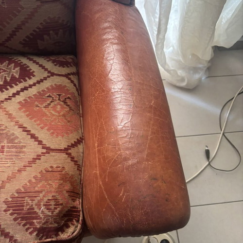 Kourtis armchair used with leather arms in brown tones