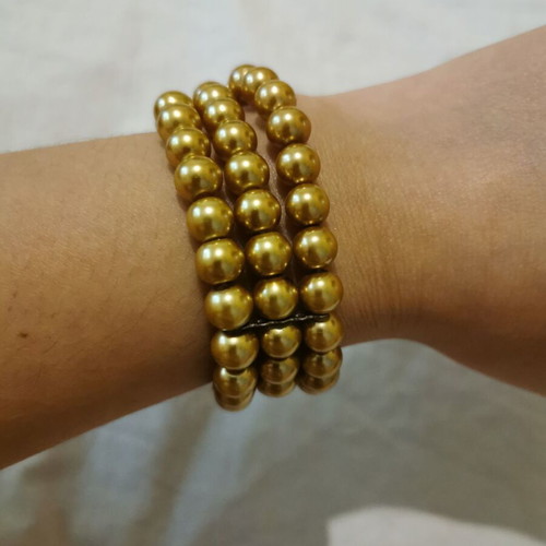 Bracelet with 3 rows of pearls in gold color like new