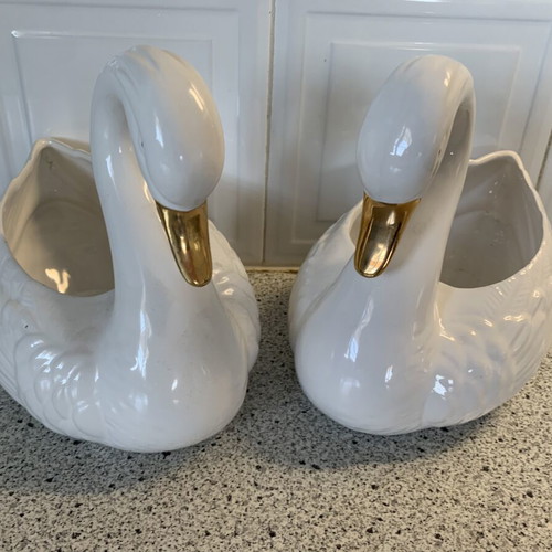 Vintage ceramic swan pair with glossy white finish and gold beak