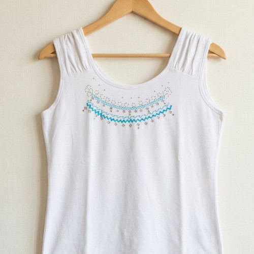 White sleeveless top used with embroidery and rhinestones size M