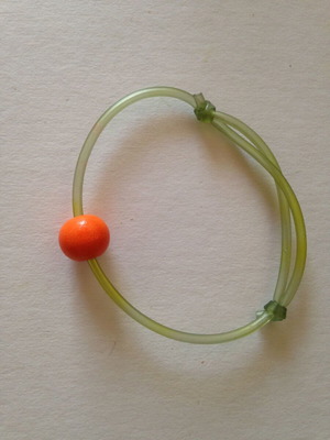Bracelet used green with orange bead