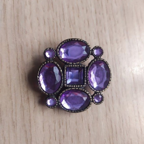 Brooch with purple stones used