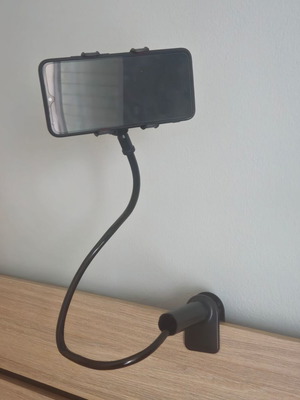 Mobile phone holder with flexible arm used, black