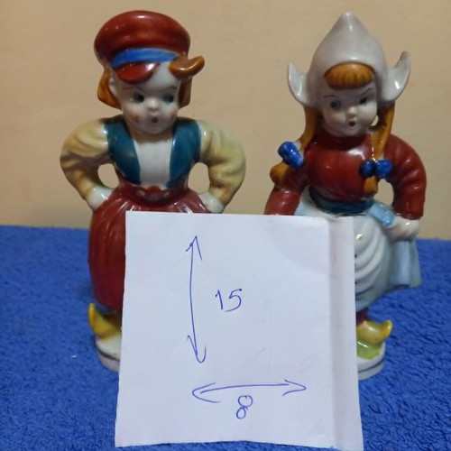 Porcelain figurines used, boy and girl in traditional Dutch costume