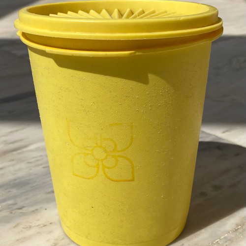 Vintage Tupperware container used yellow with radial lid