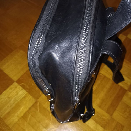 Backpack black leather type used with multiple pockets