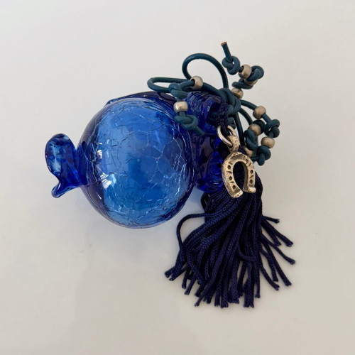 Handmade glass lucky charm in blue shades with horseshoe and silk tassel