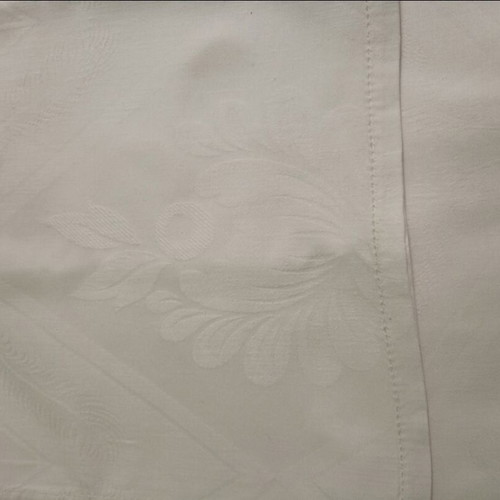 White tablecloth set with 12 used embossed napkins