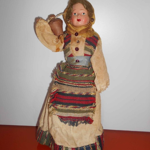 Folk handmade doll used with traditional costume and water jug