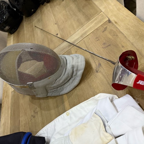 Fencing accessories used, helmet, sword, vest and bag