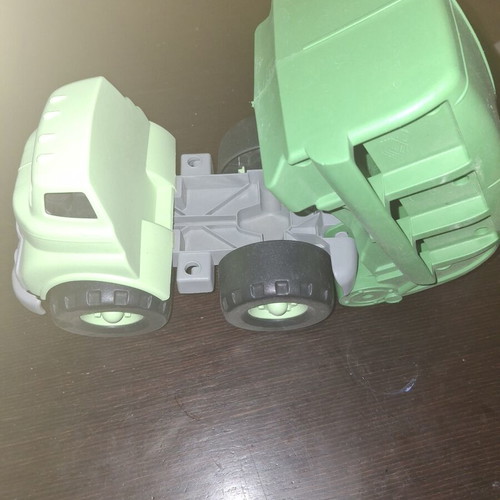 Green toy truck with opening feature